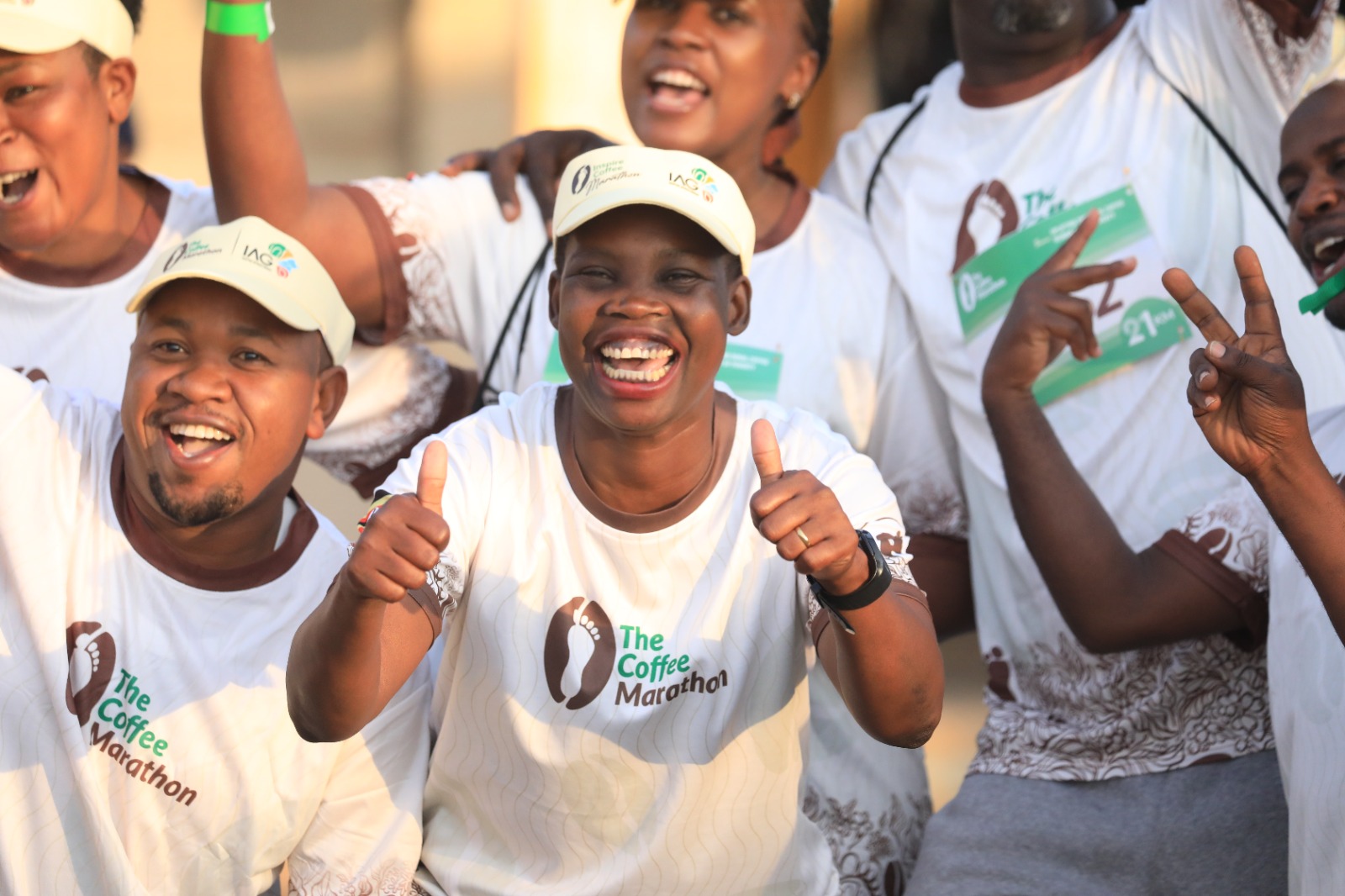 Coffee Marathon finishers celebrating in branded event shirts