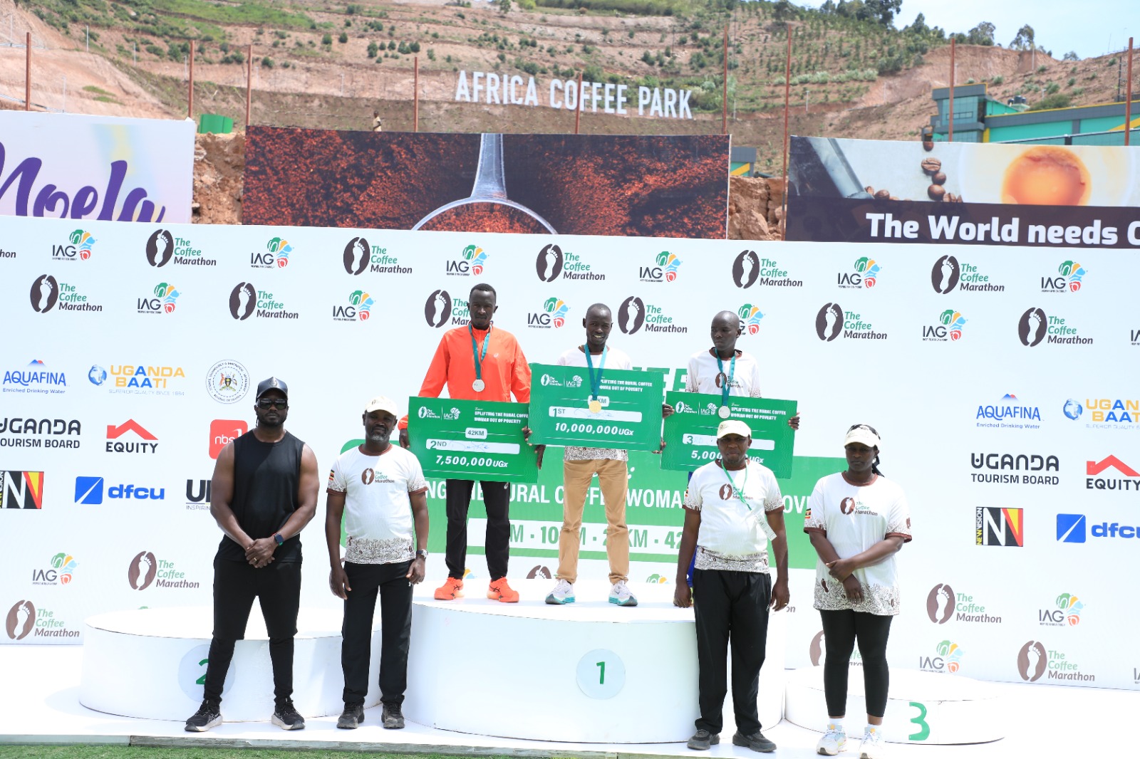 Three Coffee Marathon 21km winners raising arms together at the finish line